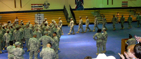The troops file into the gym for welcome ceremonies.