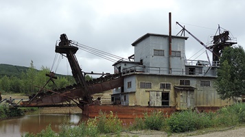 A gold dredge, long ago stopped working. 