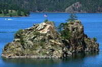The flag flying at the top of a rocky island outcrop is a wonder site to behold.
