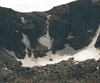 There are small snow fields or glaciers that remain all summer near the tops of the mountains.