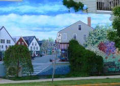 Some of the buildings have murals of the town's street scenes.