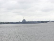 The aircraft carrier, CVA 10 can be seen on display in the harbor.
